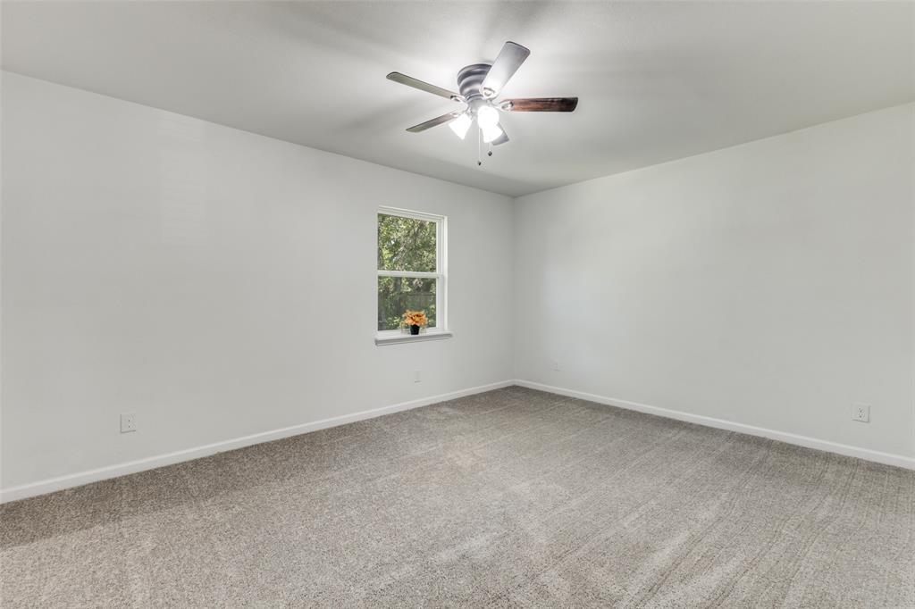 1705 Magnolia Drive Mesquite, TX 75149 - Photo 11 of 24 an empty room with a window and a fan