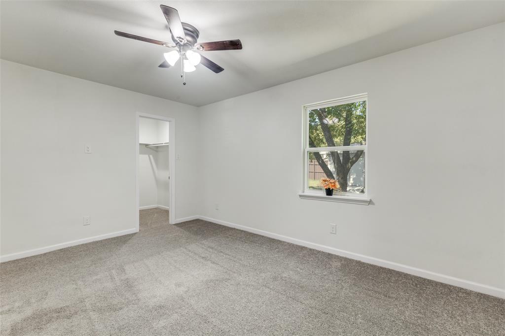 1705 Magnolia Drive Mesquite, TX 75149 - Photo 13 of 24 an empty room with windows and chandelier fan