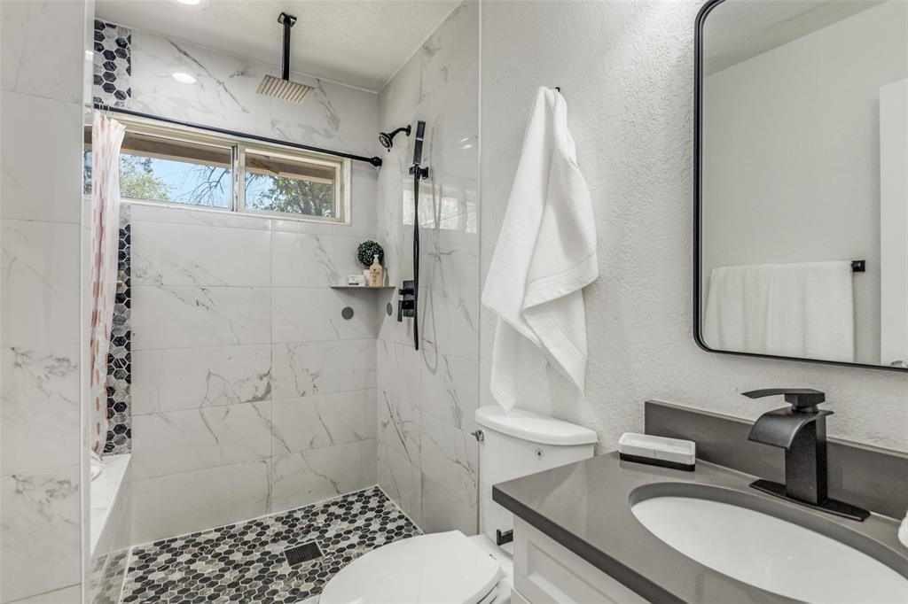 1705 Magnolia Drive Mesquite, TX 75149 - Photo 14 of 24 a bathroom with a sink toilet and shower