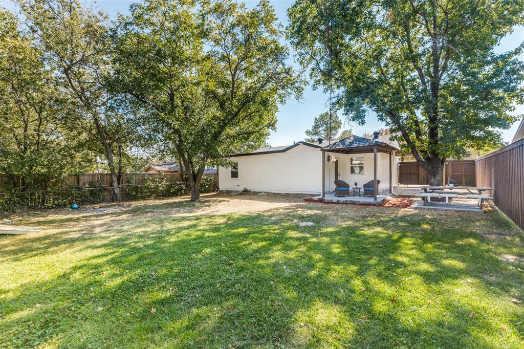 1705 Magnolia Drive Mesquite, TX 75149 - Photo 18 of 24 a backyard of a house with table and chairs