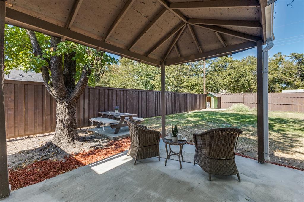 1705 Magnolia Drive Mesquite, TX 75149 - Photo 19 of 24 a view of a patio with a table chairs and a backyard