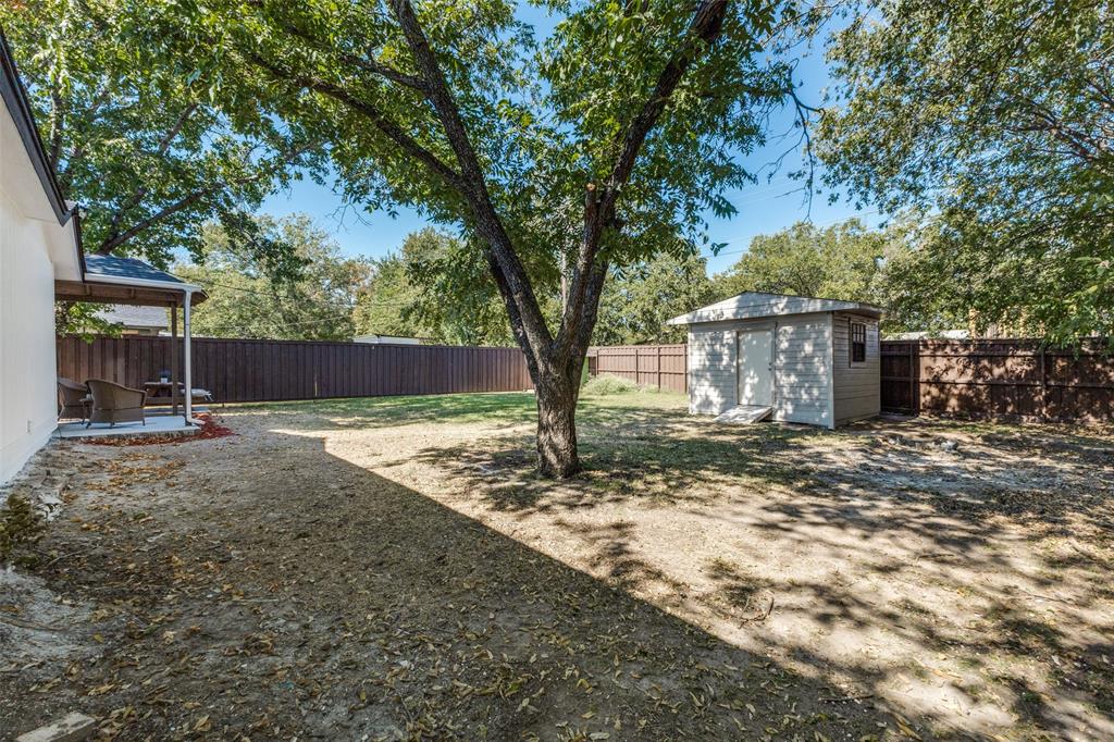 1705 Magnolia Drive Mesquite, TX 75149 - Photo 20 of 24 a view of a house with backyard and a tree