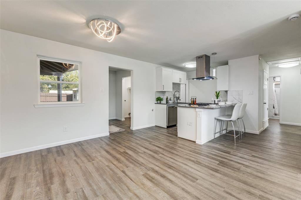 1705 Magnolia Drive Mesquite, TX 75149 - Photo 6 of 24 a view of kitchen with wooden floor and window