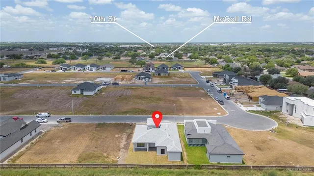 an aerial view of a house with a yard