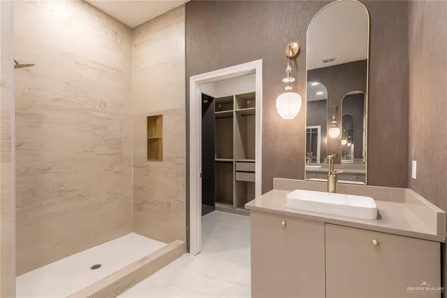 a view of walk in closet with empty racks