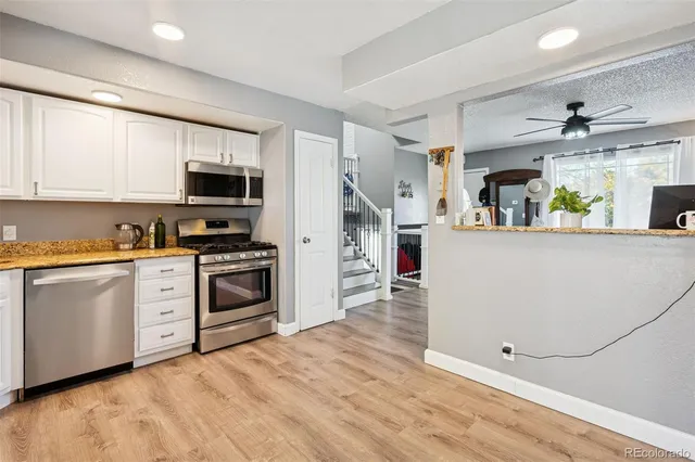 a kitchen with stainless steel appliances a refrigerator sink and stove