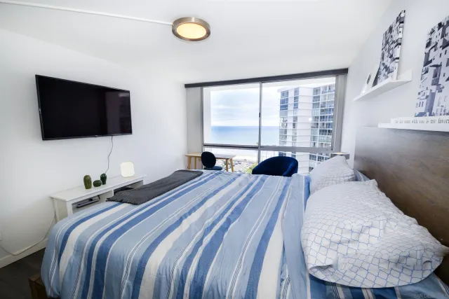 a bedroom with a bed and a flat screen tv