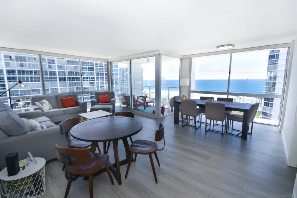 a living room with furniture and a floor to ceiling window