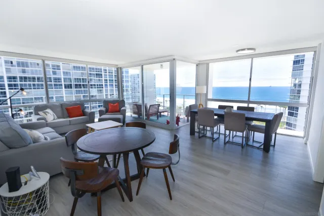 a living room with furniture and a floor to ceiling window