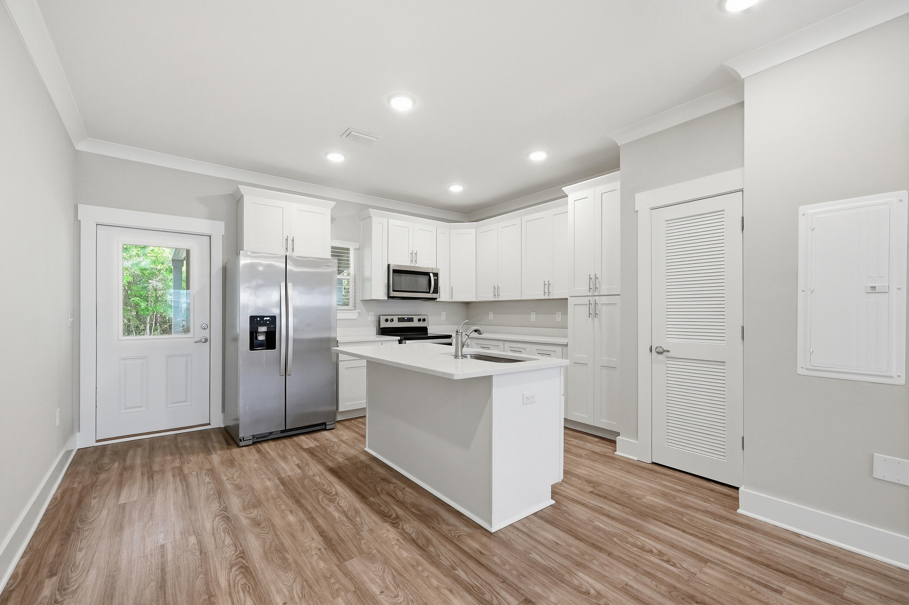 246 North Sand Palm Road Freeport, FL 32439 - Photo 11 of 42 a kitchen with stainless steel appliances a refrigerator stove and wooden floor