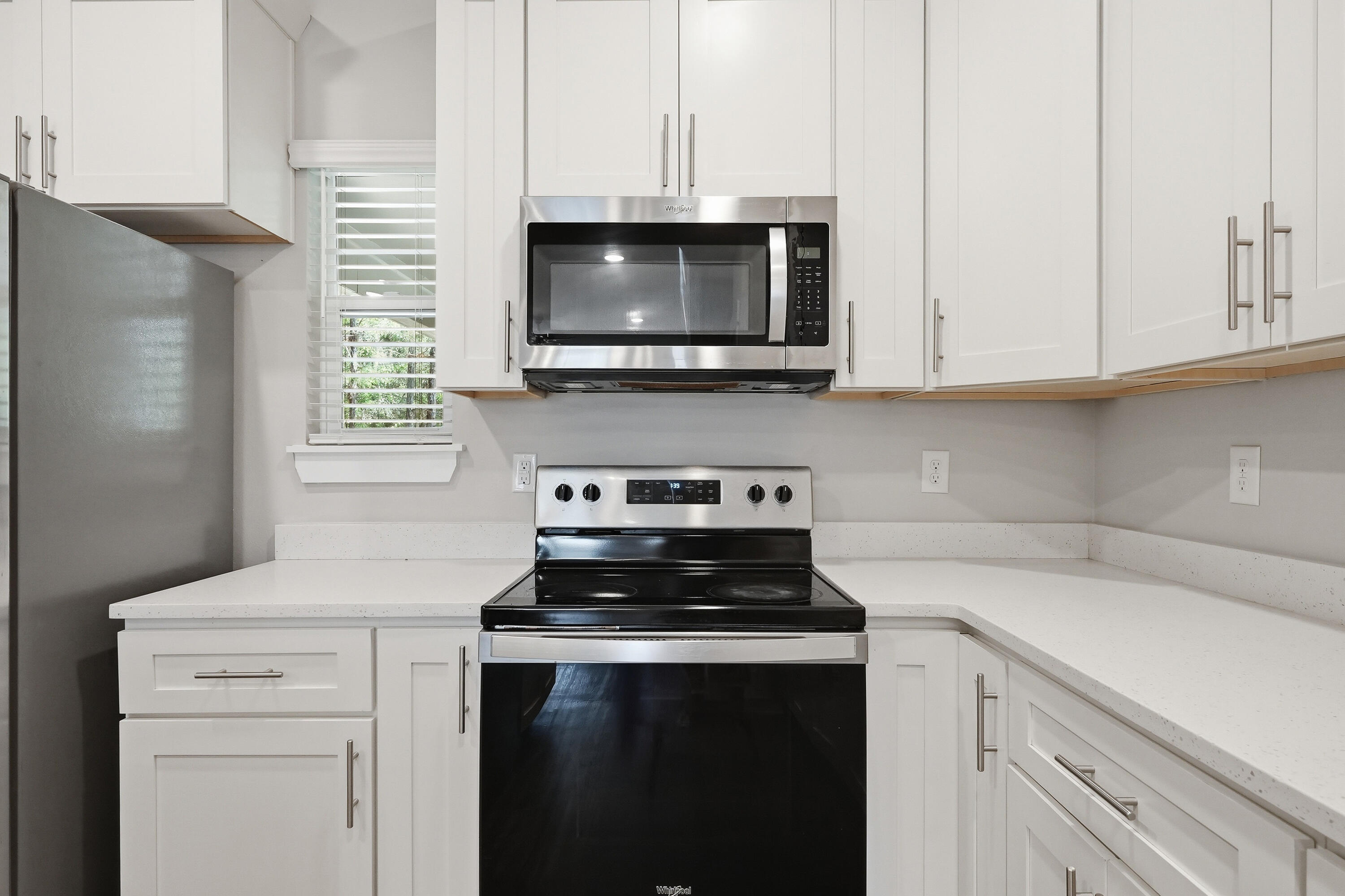246 North Sand Palm Road Freeport, FL 32439 - Photo 13 of 42 a kitchen with microwave cabinets and stove top oven