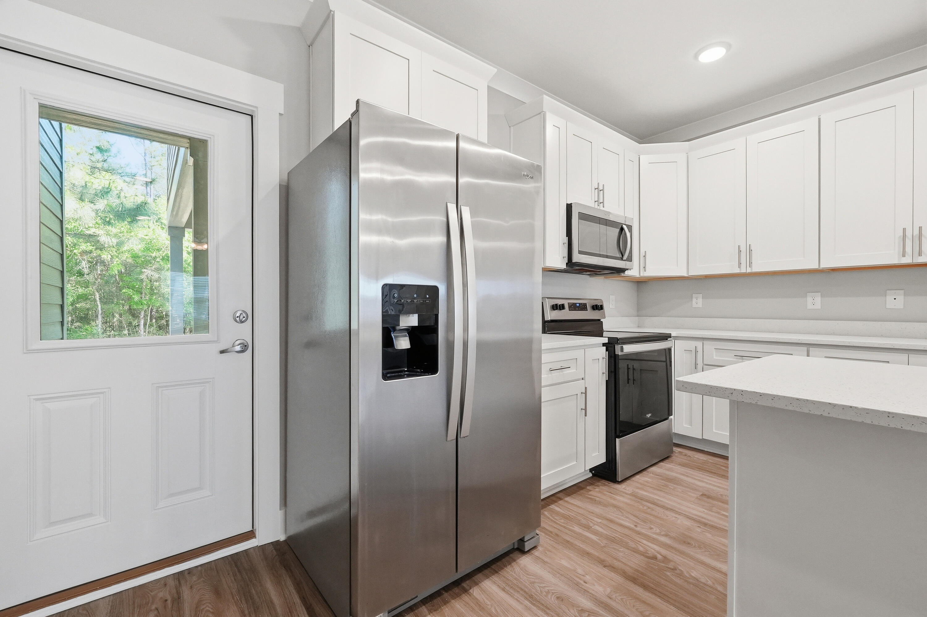 246 North Sand Palm Road Freeport, FL 32439 - Photo 14 of 42 a kitchen with stainless steel appliances granite countertop a refrigerator and a sink