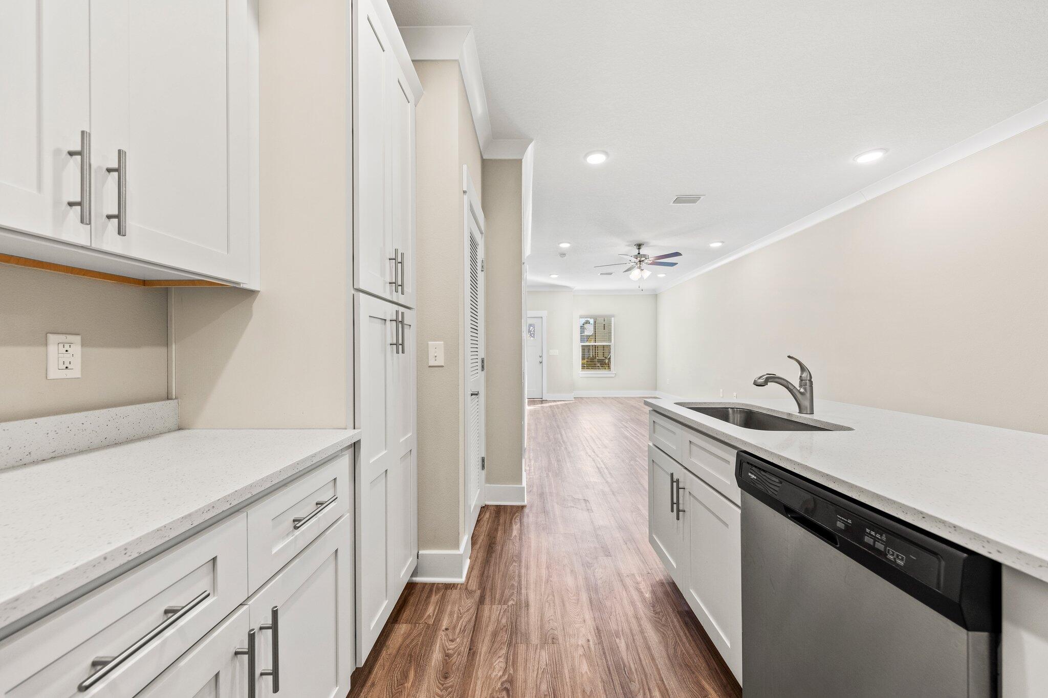 246 North Sand Palm Road Freeport, FL 32439 - Photo 14 of 36 a kitchen with a sink and wooden floor