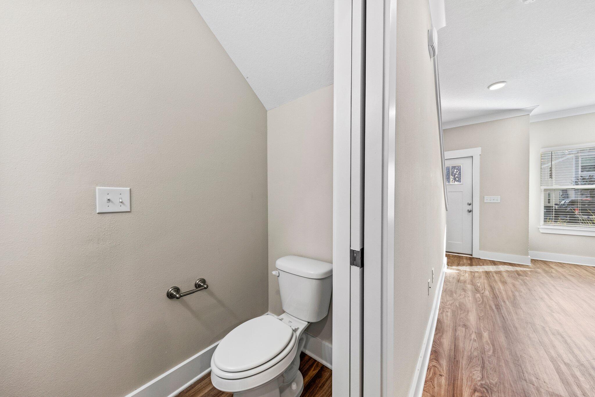 246 North Sand Palm Road Freeport, FL 32439 - Photo 16 of 36 a white toilet sitting next to a bathroom sink