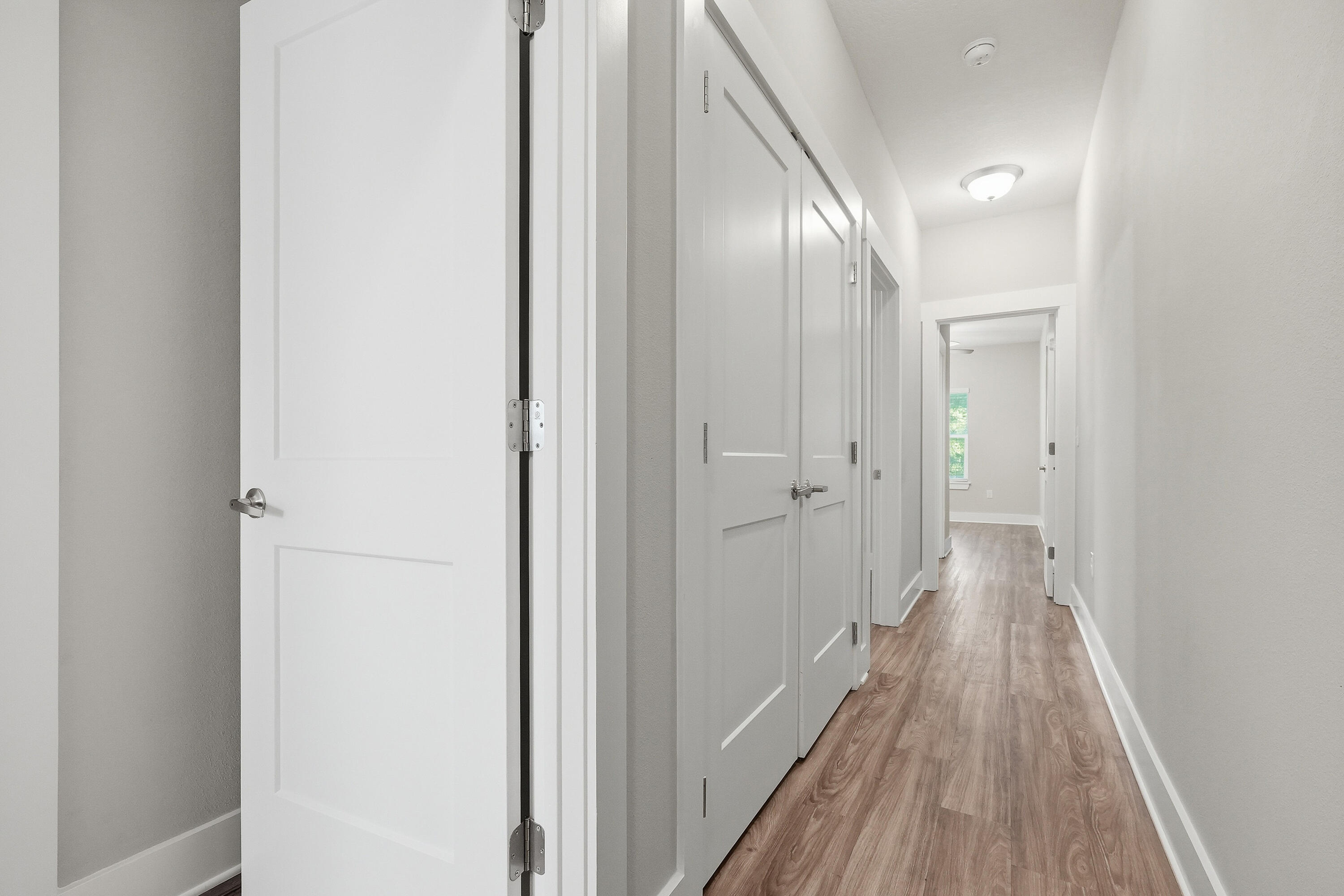 246 North Sand Palm Road Freeport, FL 32439 - Photo 17 of 42 a view of a hallway with wooden floor