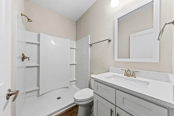 a bathroom with a sink toilet and shower