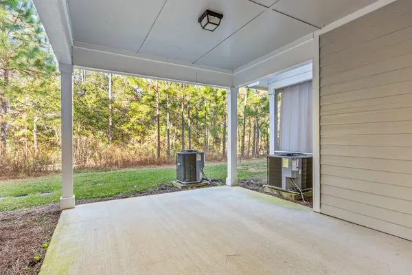a view of porch with a floor to ceiling window and a yard