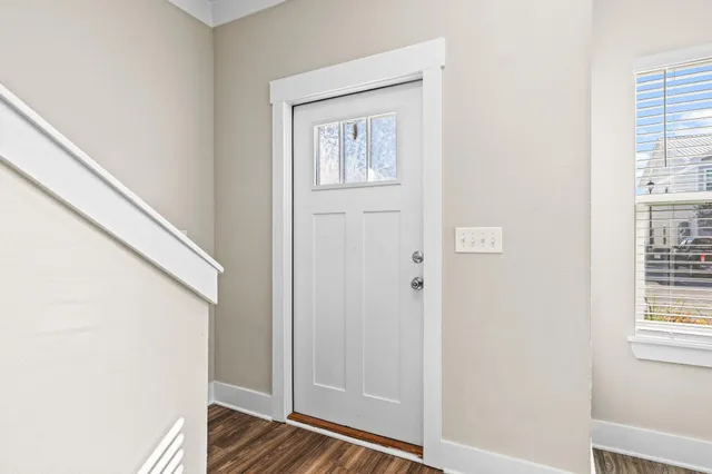a view of front door with wooden floor