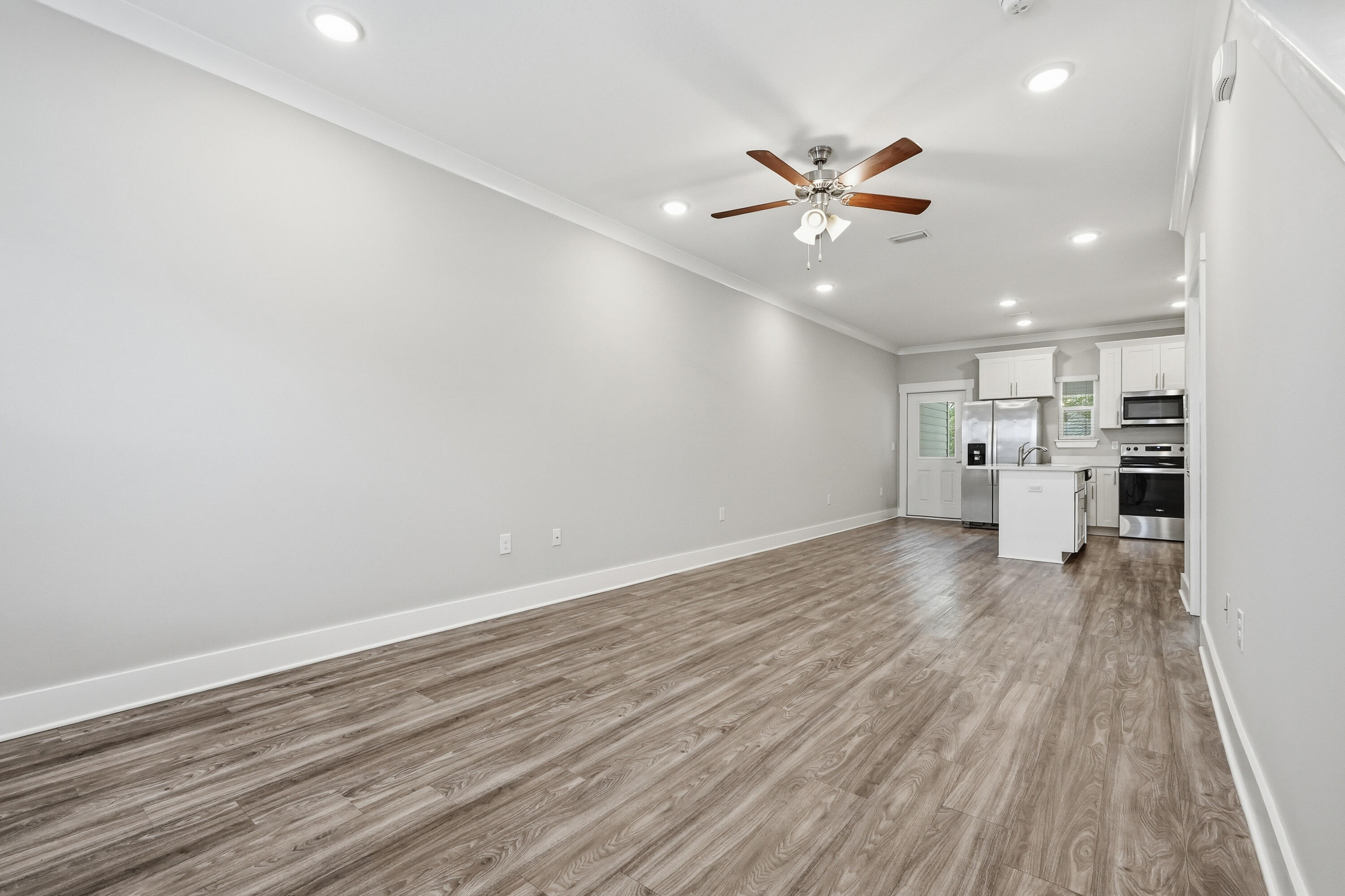 246 North Sand Palm Road Freeport, FL 32439 - Photo 4 of 42 a view of a kitchen with a dishwasher and wooden floor