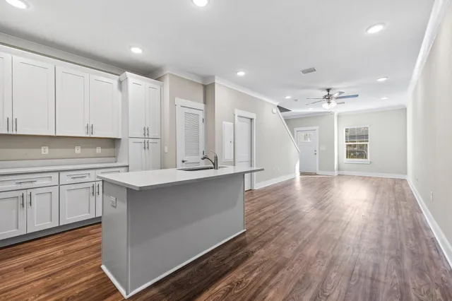 a view of kitchen with granite countertop cabinets and wooden floor