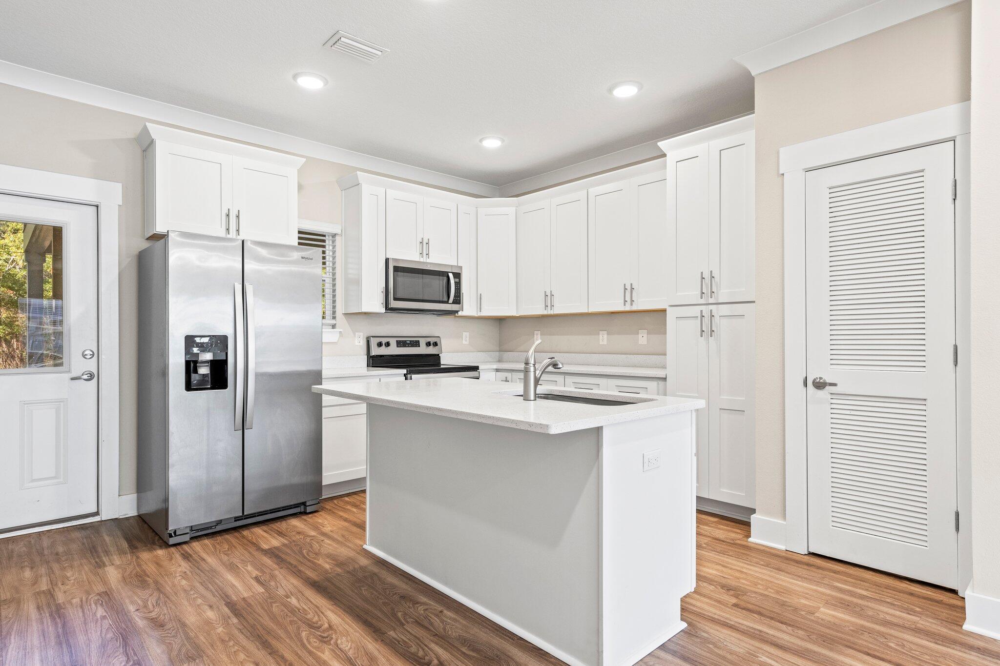 246 North Sand Palm Road Freeport, FL 32439 - Photo 9 of 36 a kitchen with stainless steel appliances a refrigerator sink and microwave