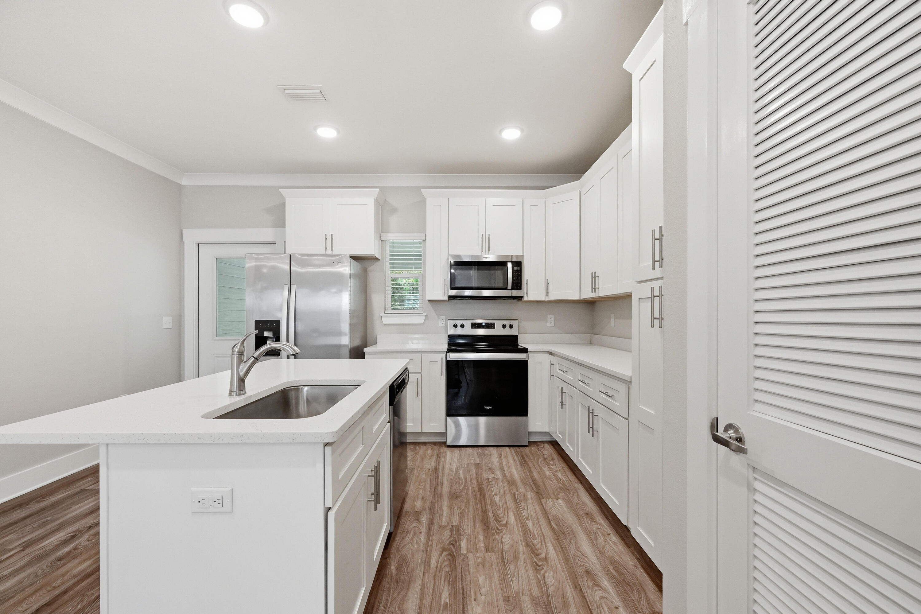 246 North Sand Palm Road Freeport, FL 32439 - Photo 10 of 42 a kitchen with kitchen island granite countertop a sink and appliances