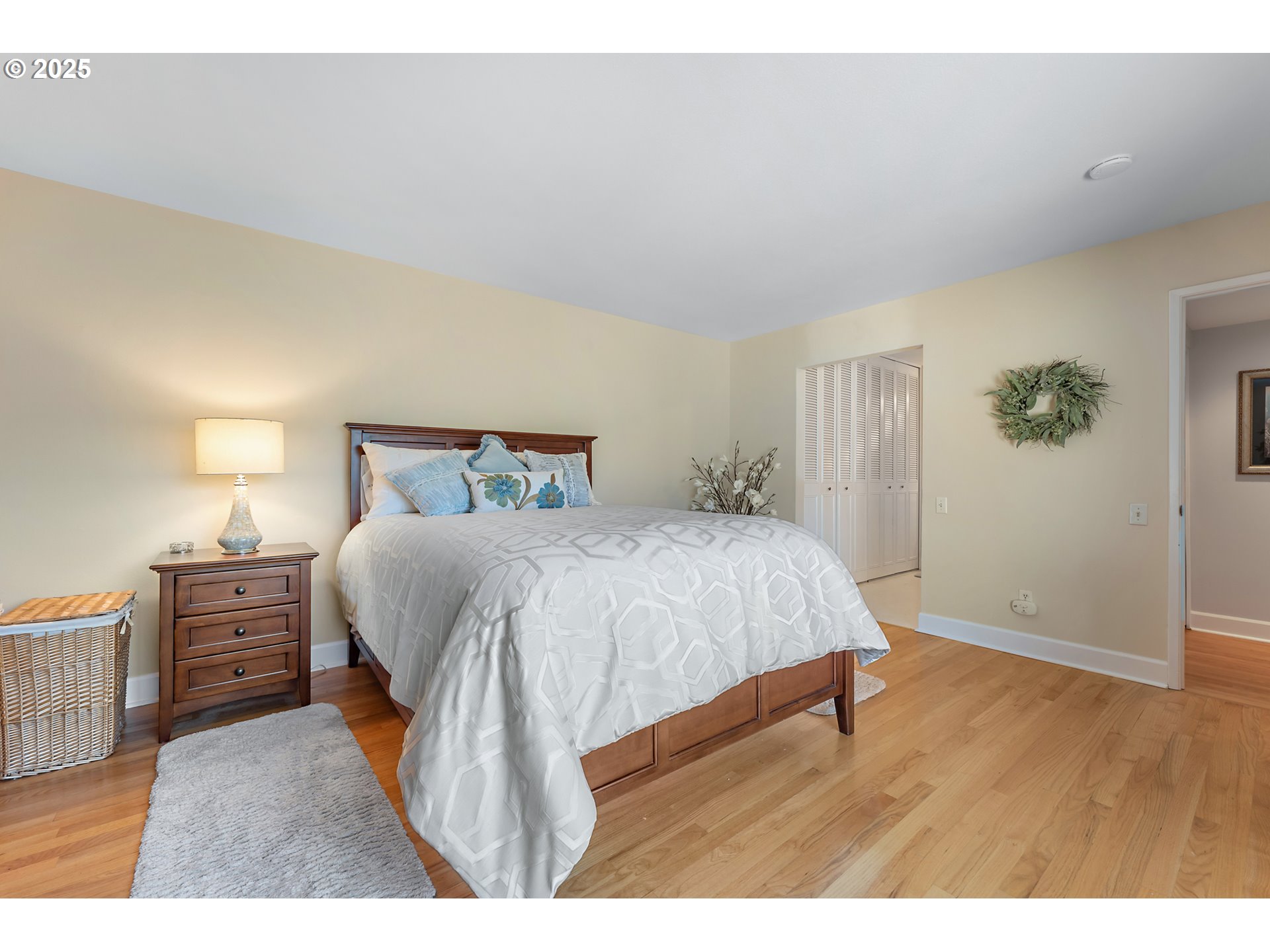 15730 Southwest Greens Way Portland, OR 97224 - Photo 23 of 42 a bedroom with a bed and wooden floor