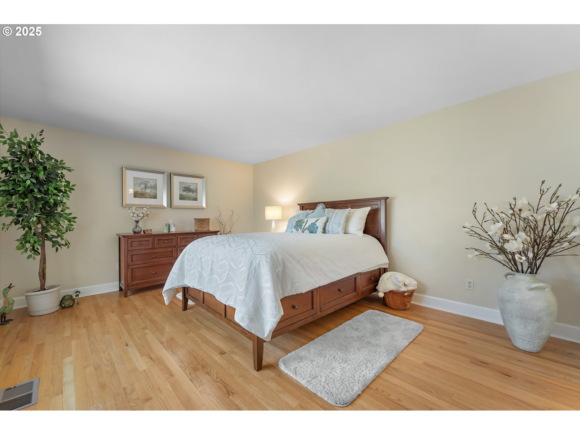 15730 Southwest Greens Way Portland, OR 97224 - Photo 24 of 42 a bedroom with a bed and a potted plant