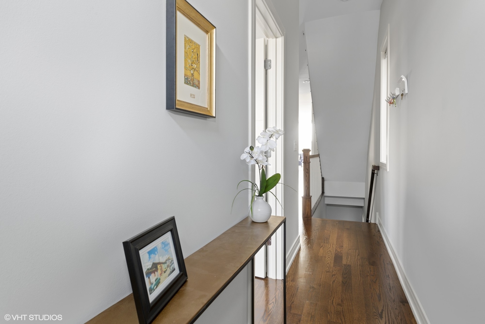 1532 North Artesian Avenue, Unit 3 Chicago, IL 60622 - Photo 16 of 25 a view of a hallway with wooden floor and a potted plant