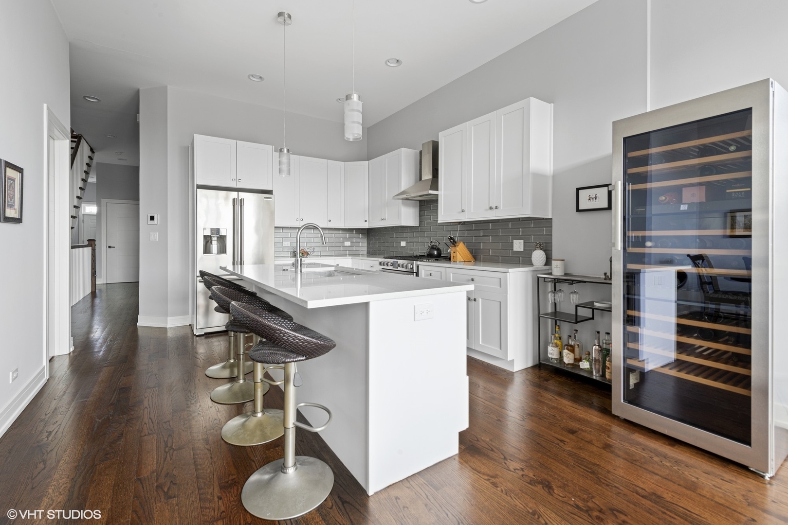 1532 North Artesian Avenue, Unit 3 Chicago, IL 60622 - Photo 7 of 25 a kitchen with stainless steel appliances granite countertop a sink cabinets and wooden floor