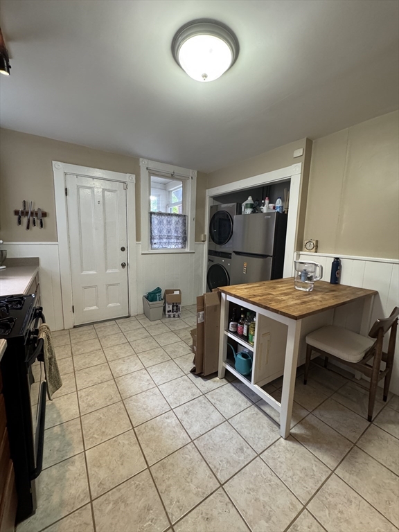 5 Spring Park Avenue, Unit 1 Boston, MA 02130 - Photo 9 of 24 a room with a bed and a table chair