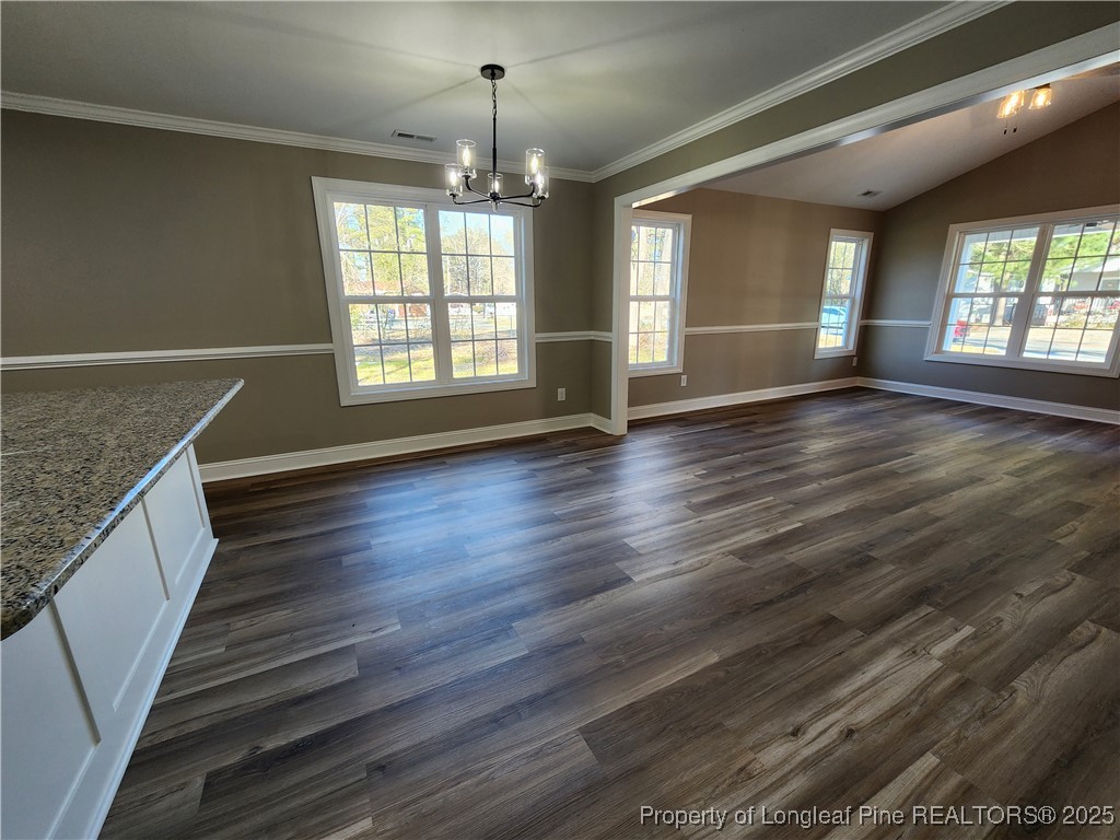 910 West Street Smithfield, NC 27577 - Photo 16 of 47 an empty room with wooden floor and windows