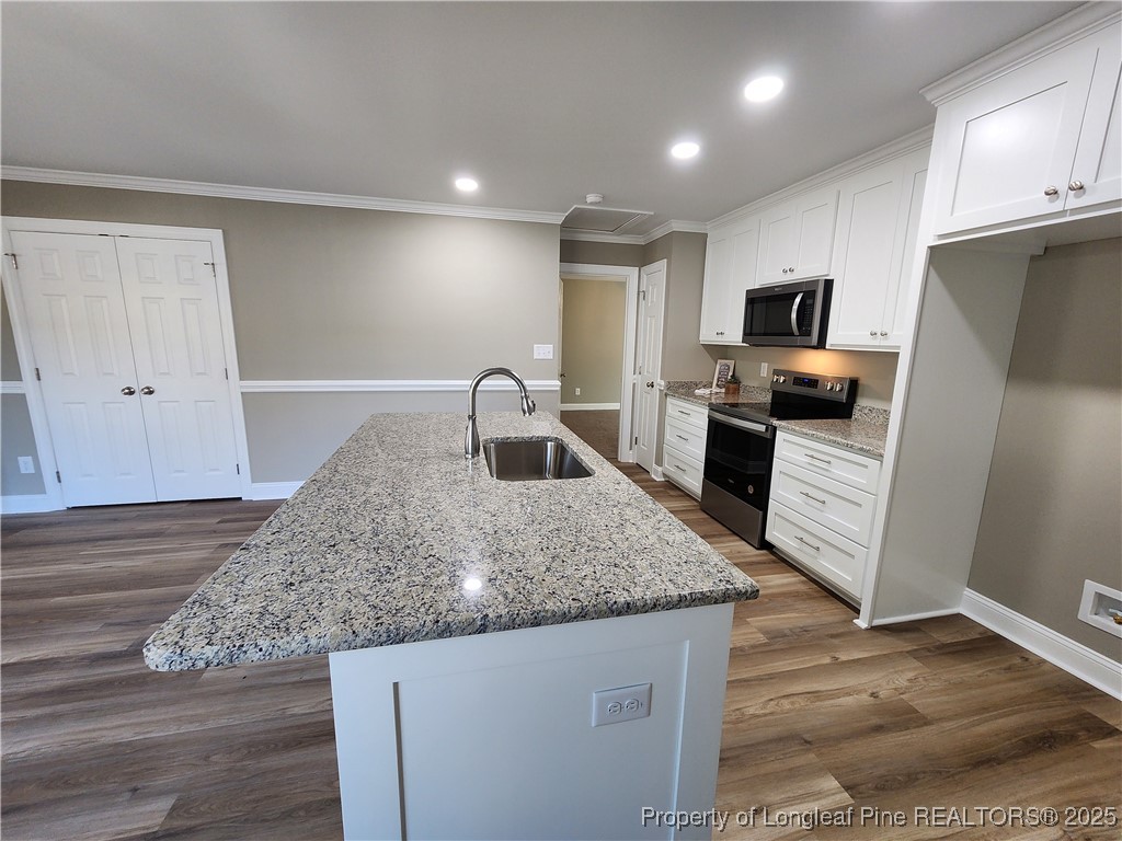 910 West Street Smithfield, NC 27577 - Photo 18 of 47 a kitchen with kitchen island granite countertop a sink stove and refrigerator