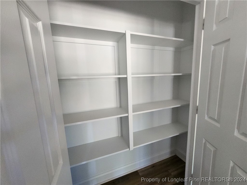910 West Street Smithfield, NC 27577 - Photo 29 of 47 a view of walk in closet with empty racks