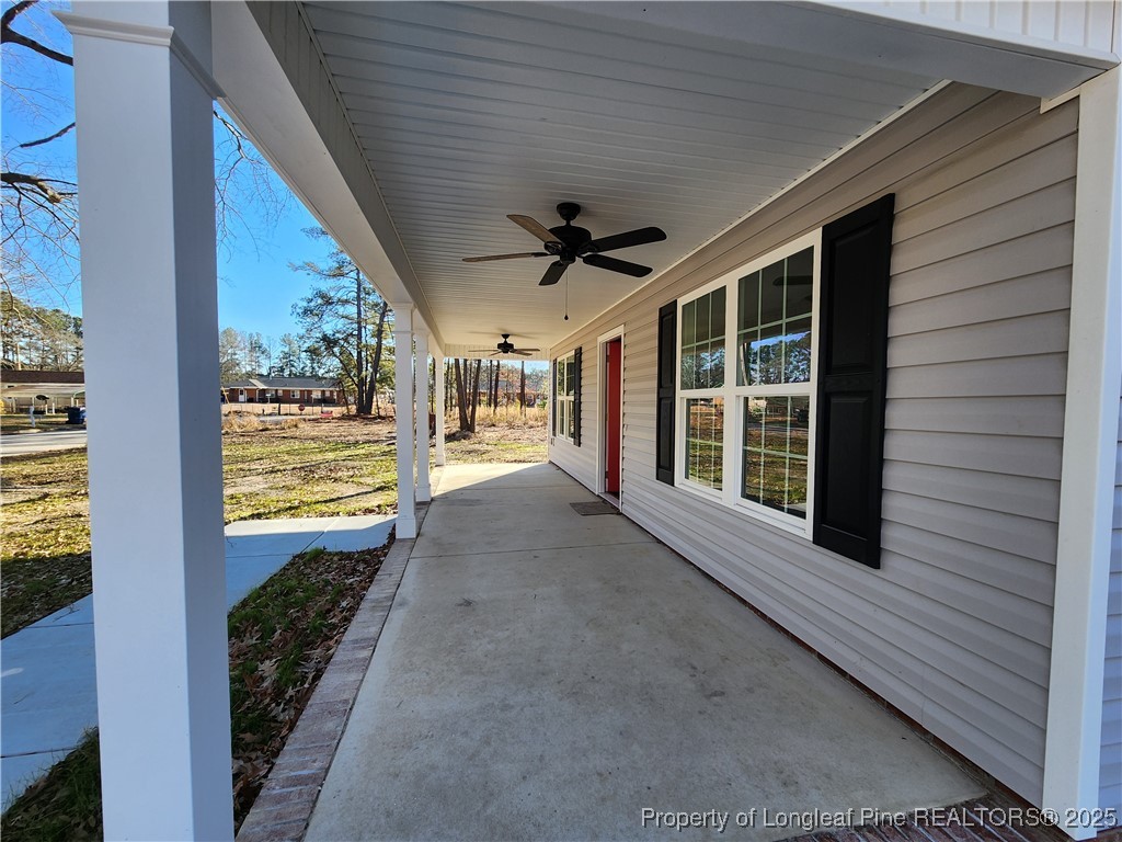 910 West Street Smithfield, NC 27577 - Photo 6 of 47 a view of a porch with wooden floor and a ceiling fan