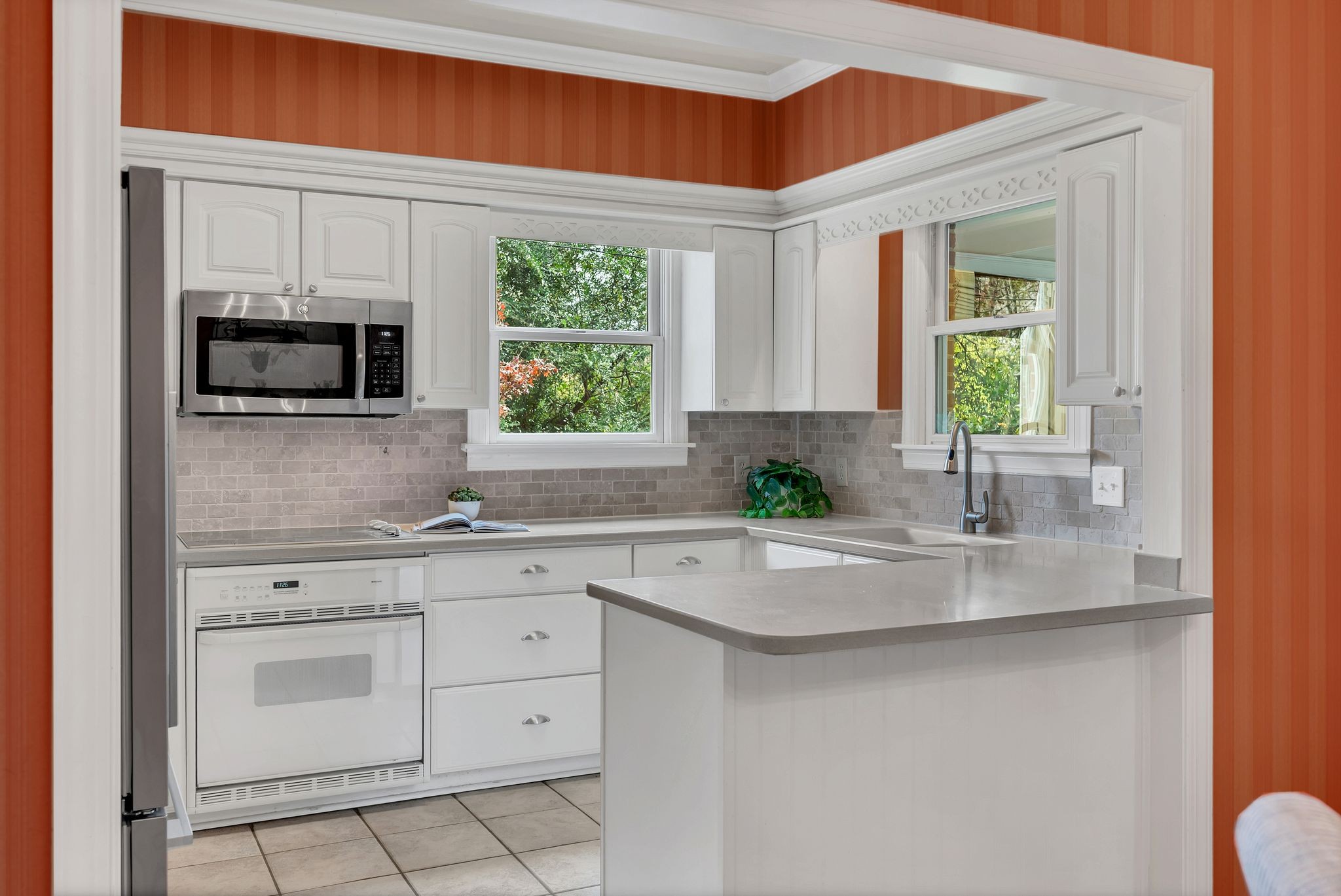 620 Estes Road Nashville, TN 37215 - Photo 15 of 40 a kitchen with white cabinets and window