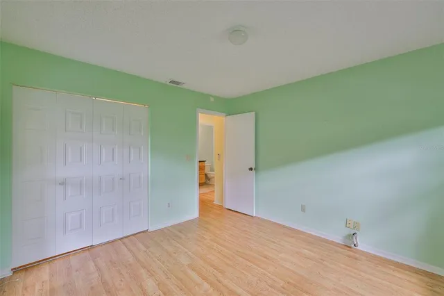 a bathroom with a granite countertop toilet sink mirror and vanity