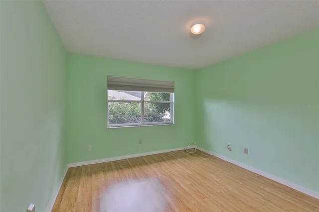 a view of room with wooden floor