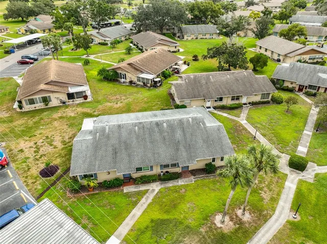 an aerial view of residential houses with outdoor space and swimming pool