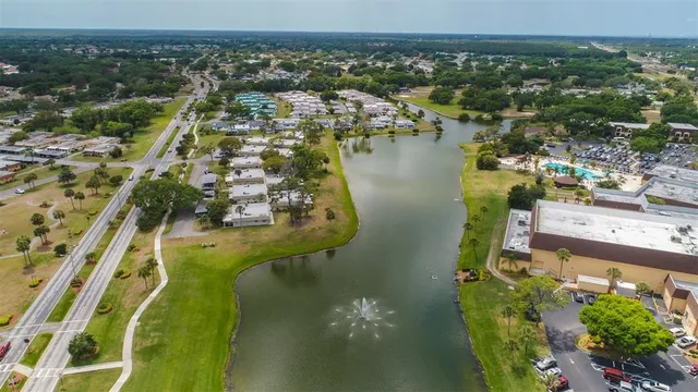 an aerial view of a house with a garden and lake view