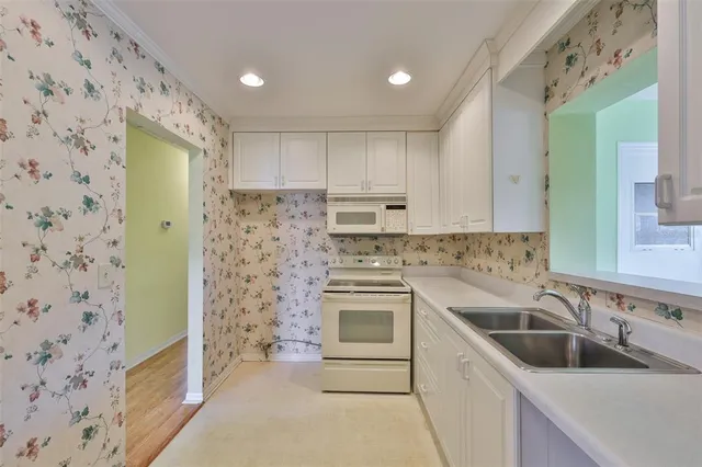 a kitchen with a sink stove and refrigerator