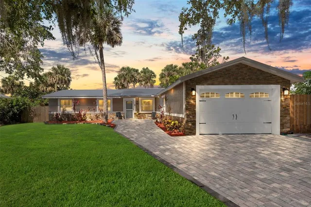 a front view of a house with yard porch and garage