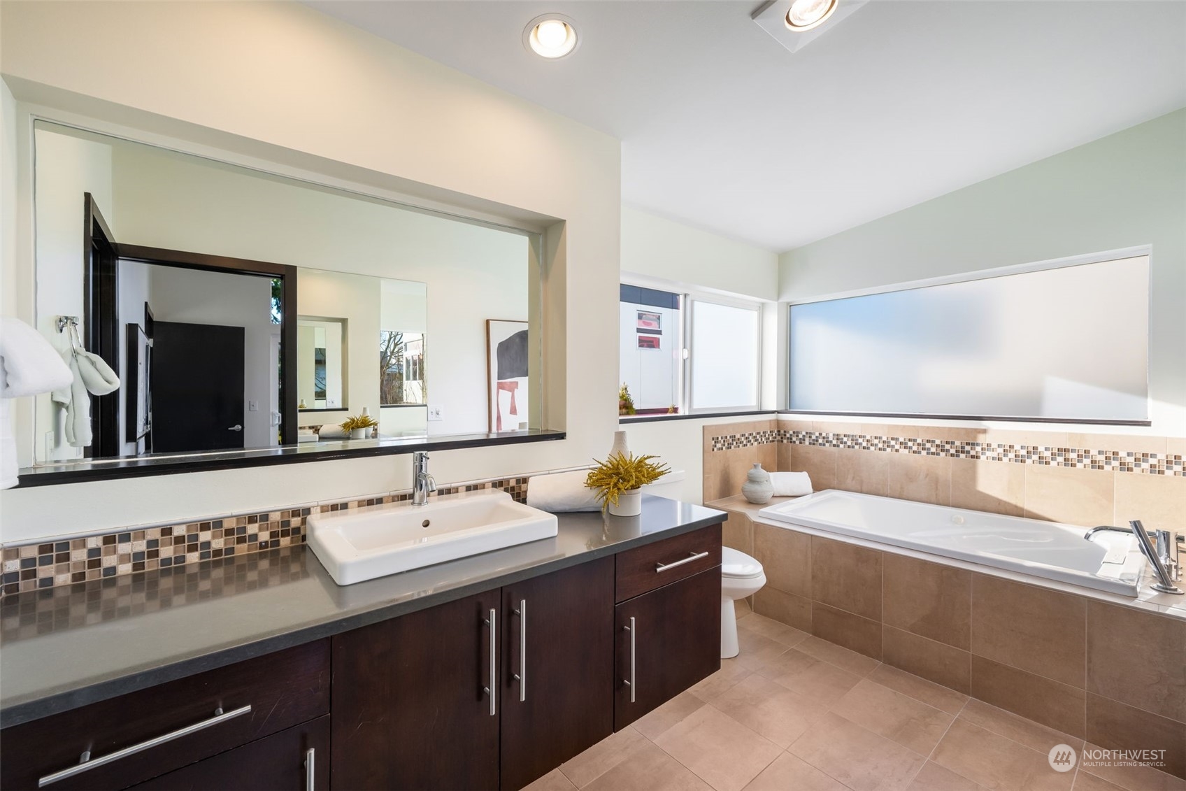 830 Northwest 53rd Street, Unit B Seattle, WA 98107 - Photo 14 of 28 a bathroom with a tub sink and mirror