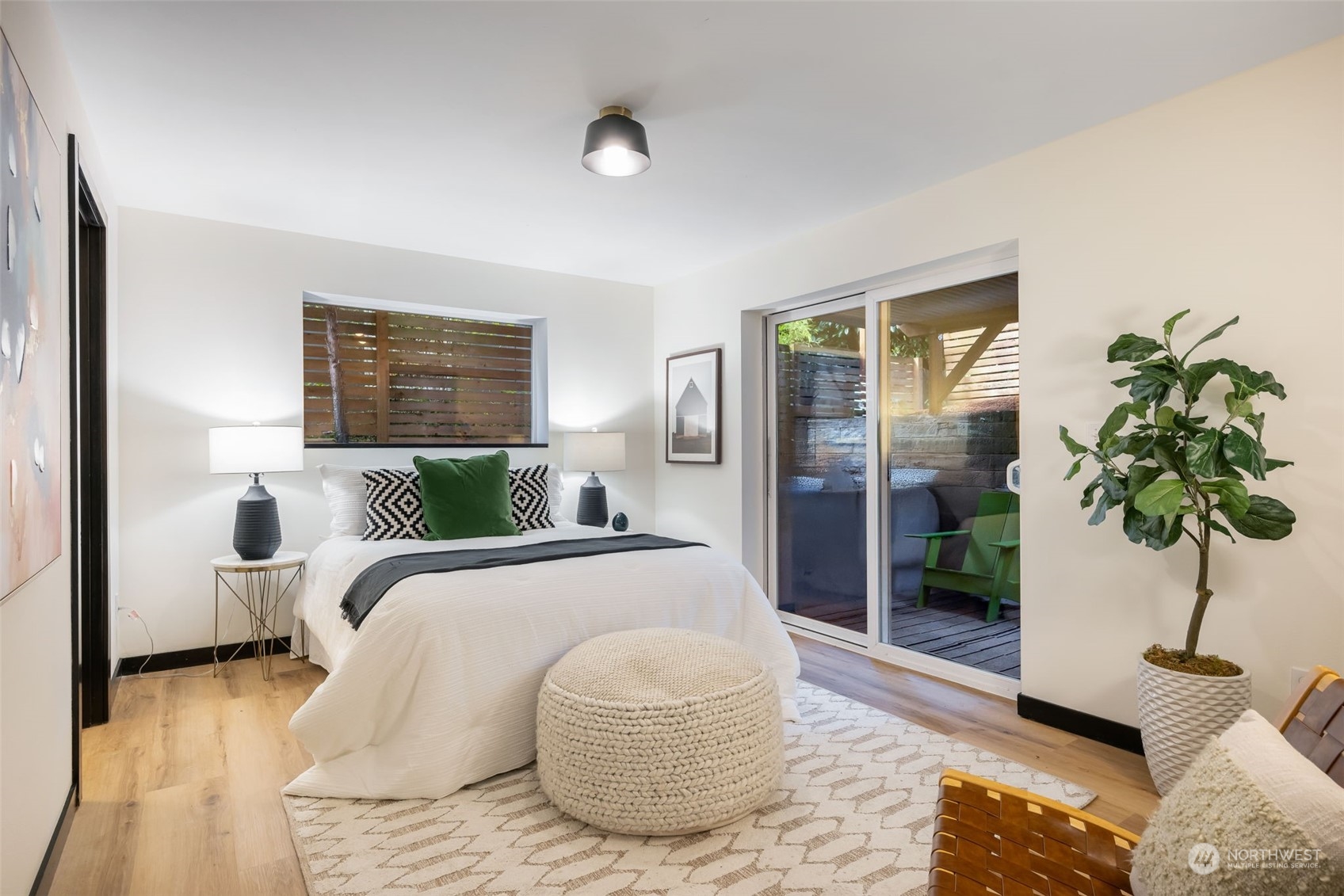 830 Northwest 53rd Street, Unit B Seattle, WA 98107 - Photo 18 of 28 a bedroom with a bed and a potted plant