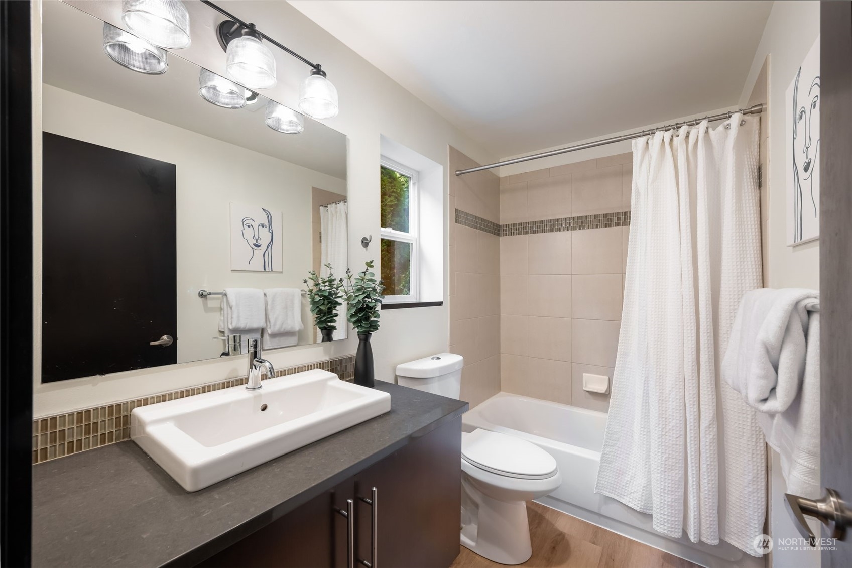 830 Northwest 53rd Street, Unit B Seattle, WA 98107 - Photo 19 of 28 a bathroom with a sink toilet a mirror and shower
