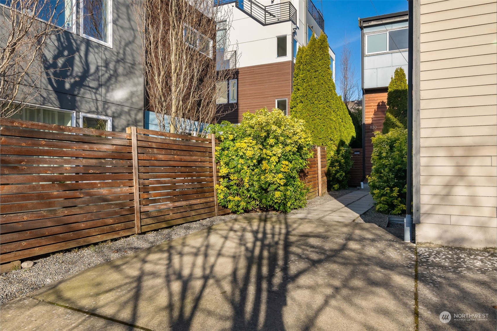830 Northwest 53rd Street, Unit B Seattle, WA 98107 - Photo 2 of 28 a view of a pathway both side of building