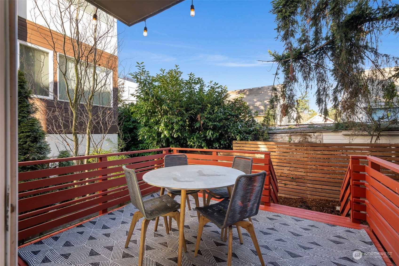 830 Northwest 53rd Street, Unit B Seattle, WA 98107 - Photo 23 of 28 a backyard of a house with table and chairs