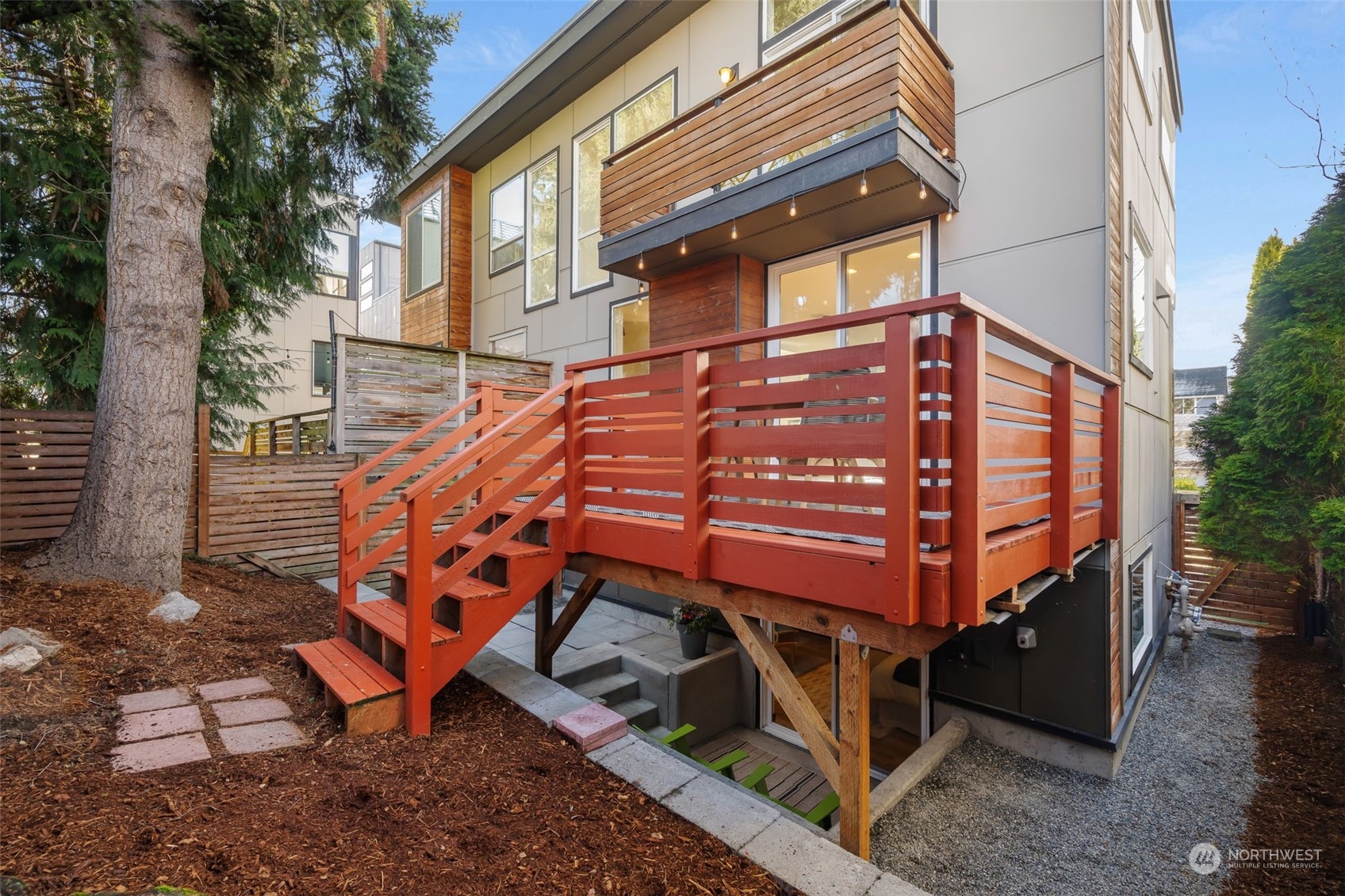 830 Northwest 53rd Street, Unit B Seattle, WA 98107 - Photo 28 of 28 a backyard of a house with a bench and wooden floor