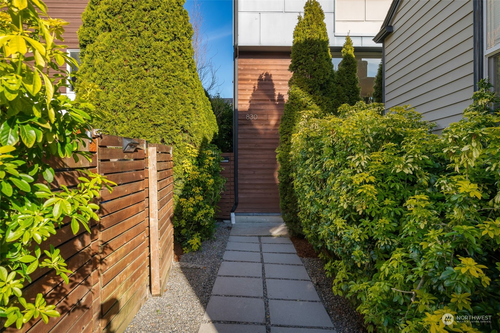 830 Northwest 53rd Street, Unit B Seattle, WA 98107 - Photo 3 of 28 a view of a pathway with flower plants