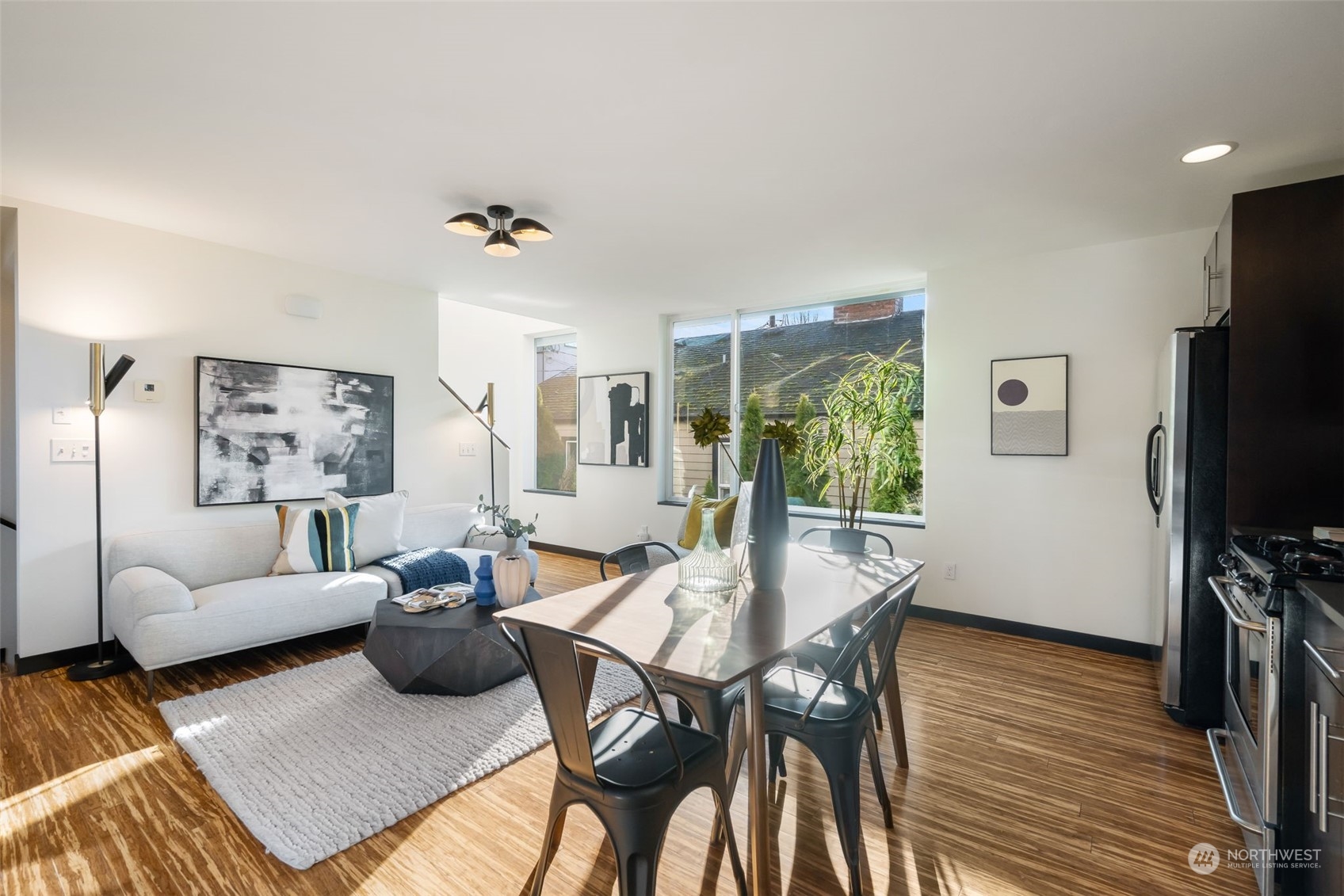 830 Northwest 53rd Street, Unit B Seattle, WA 98107 - Photo 9 of 28 a living room with furniture a flat screen tv and a large window
